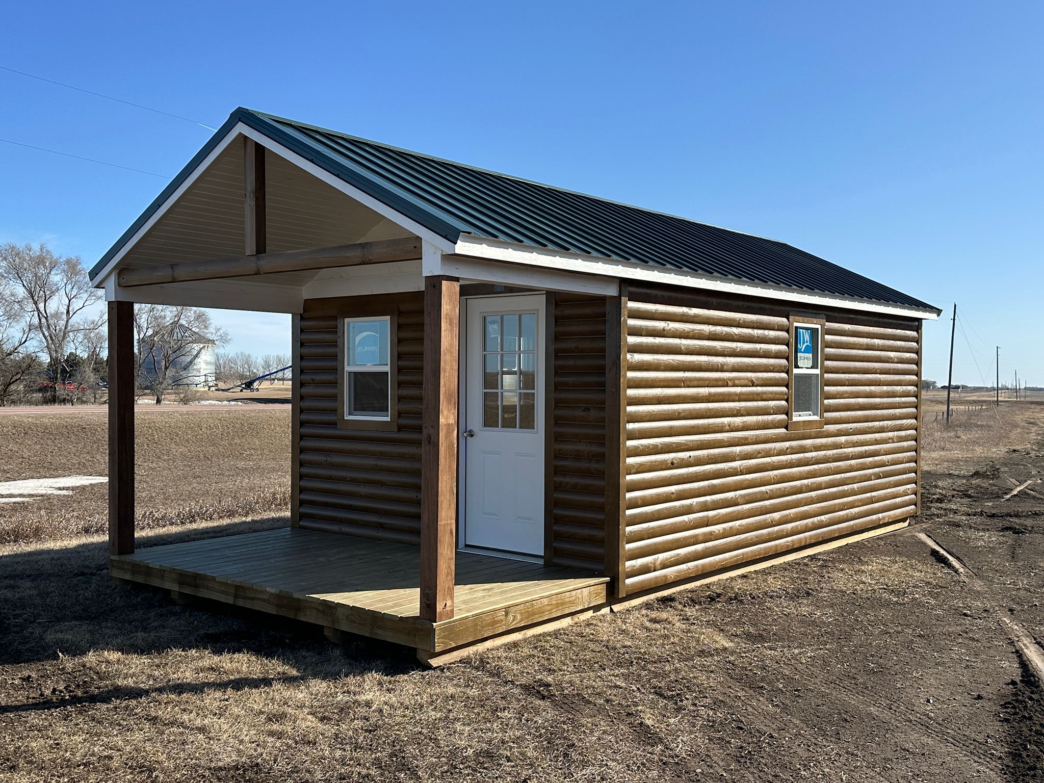 12x20 log sided cabin shell with black metal roof in South Dakota