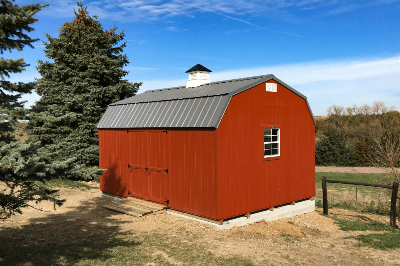 Red shed for sale in Nebraska on a concrete pad