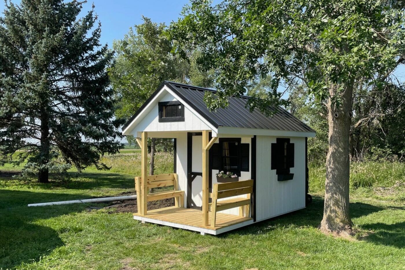 White playhouse shed in backyard