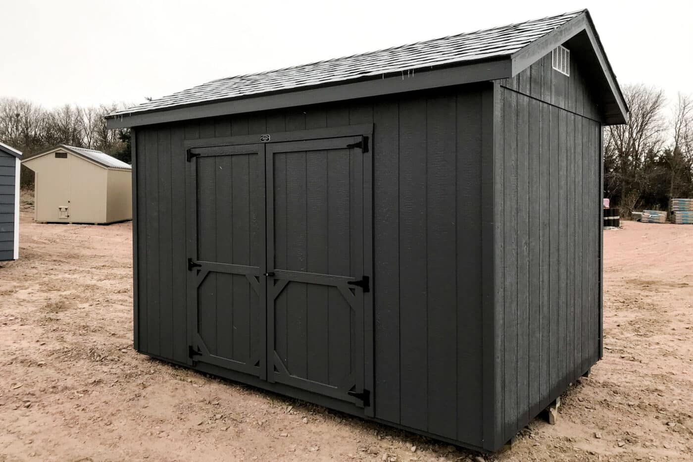 Black Ranch Style gable shed in field