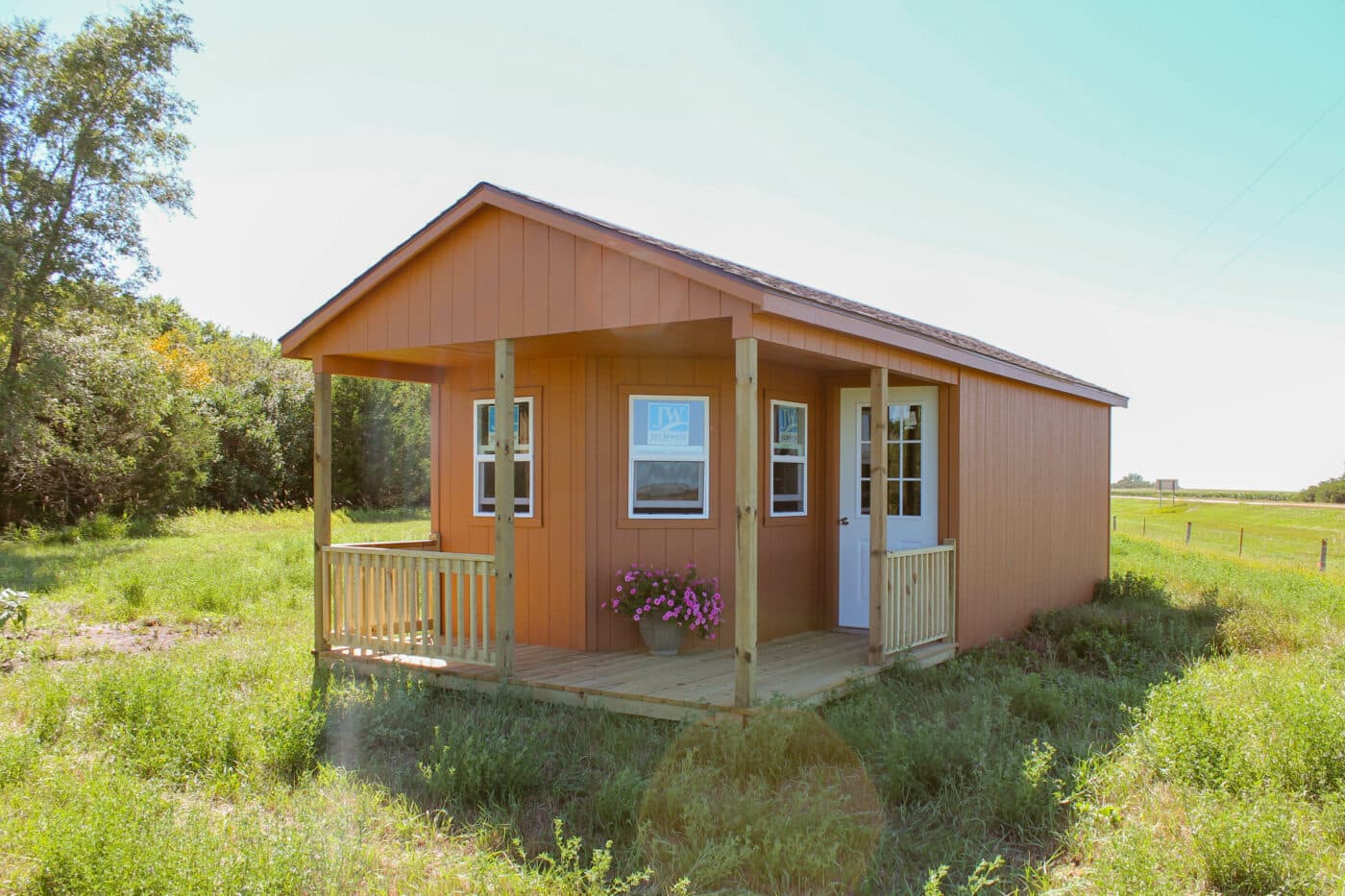 Brown A-Frame Cabin shed with wraparound porch