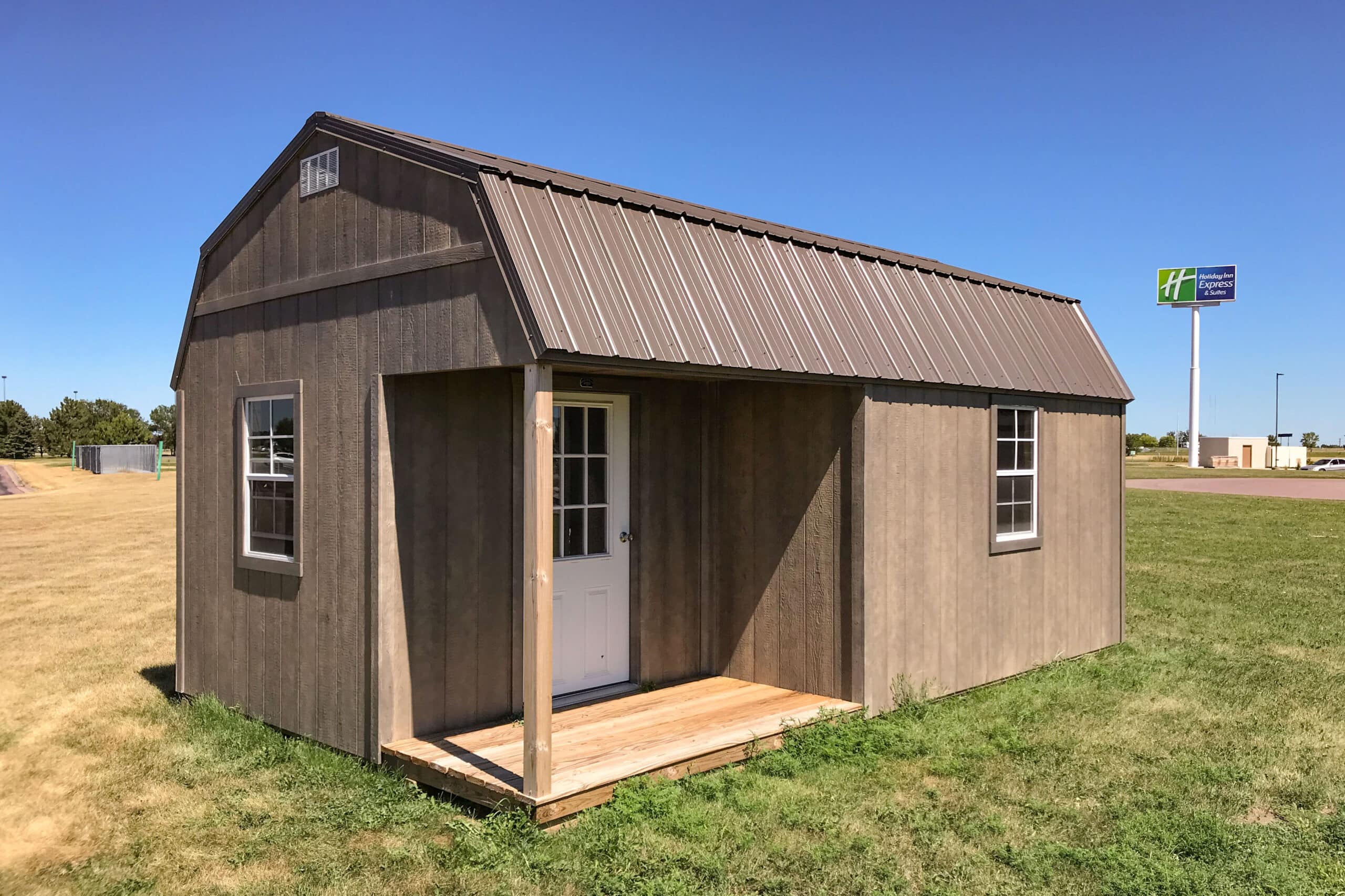 Brown high barn prefab cabins with corner porch