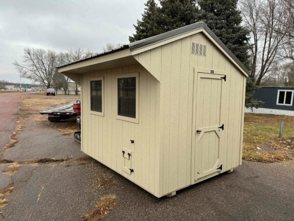Beige Quaker shed in shed lot