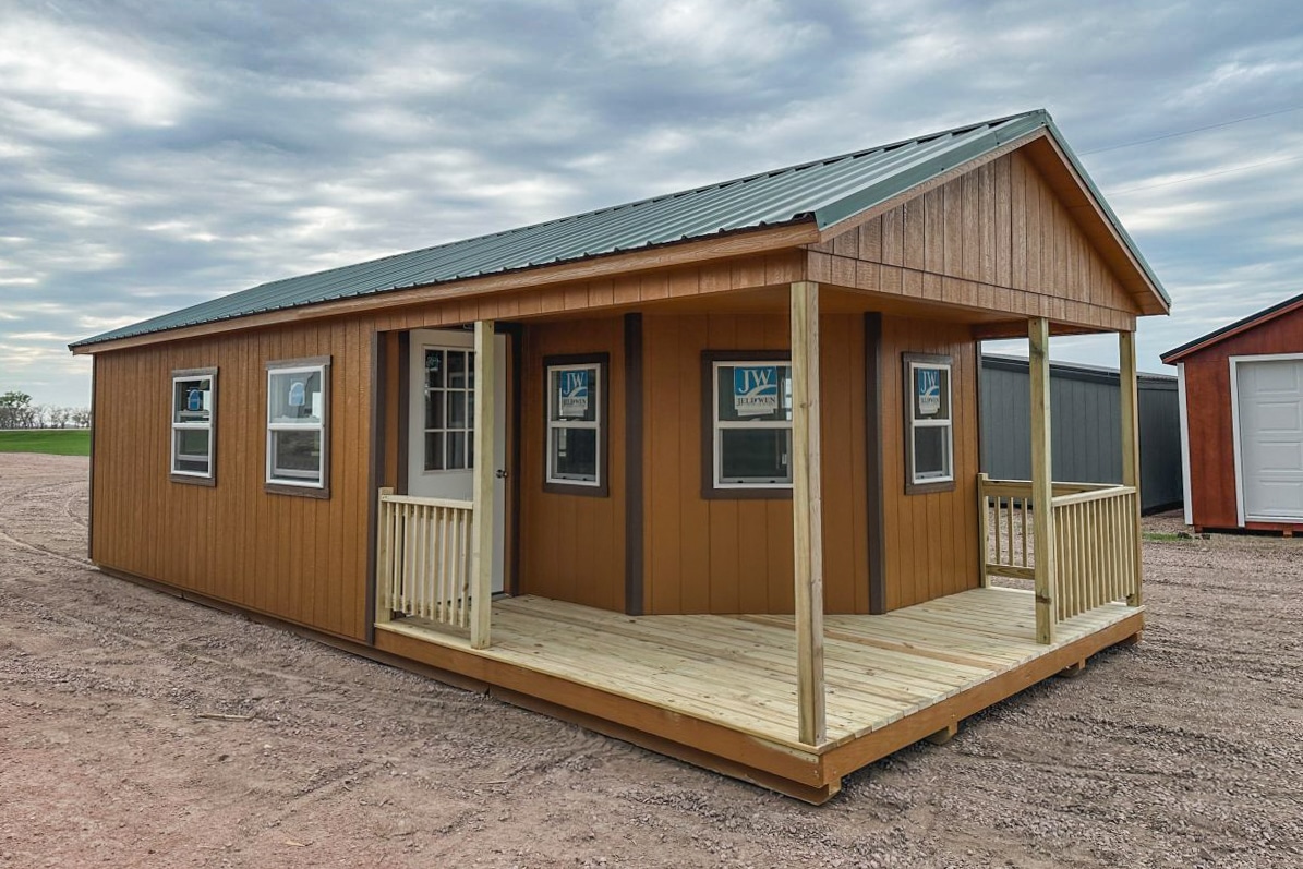 Cabin storage shed with wraparound porch