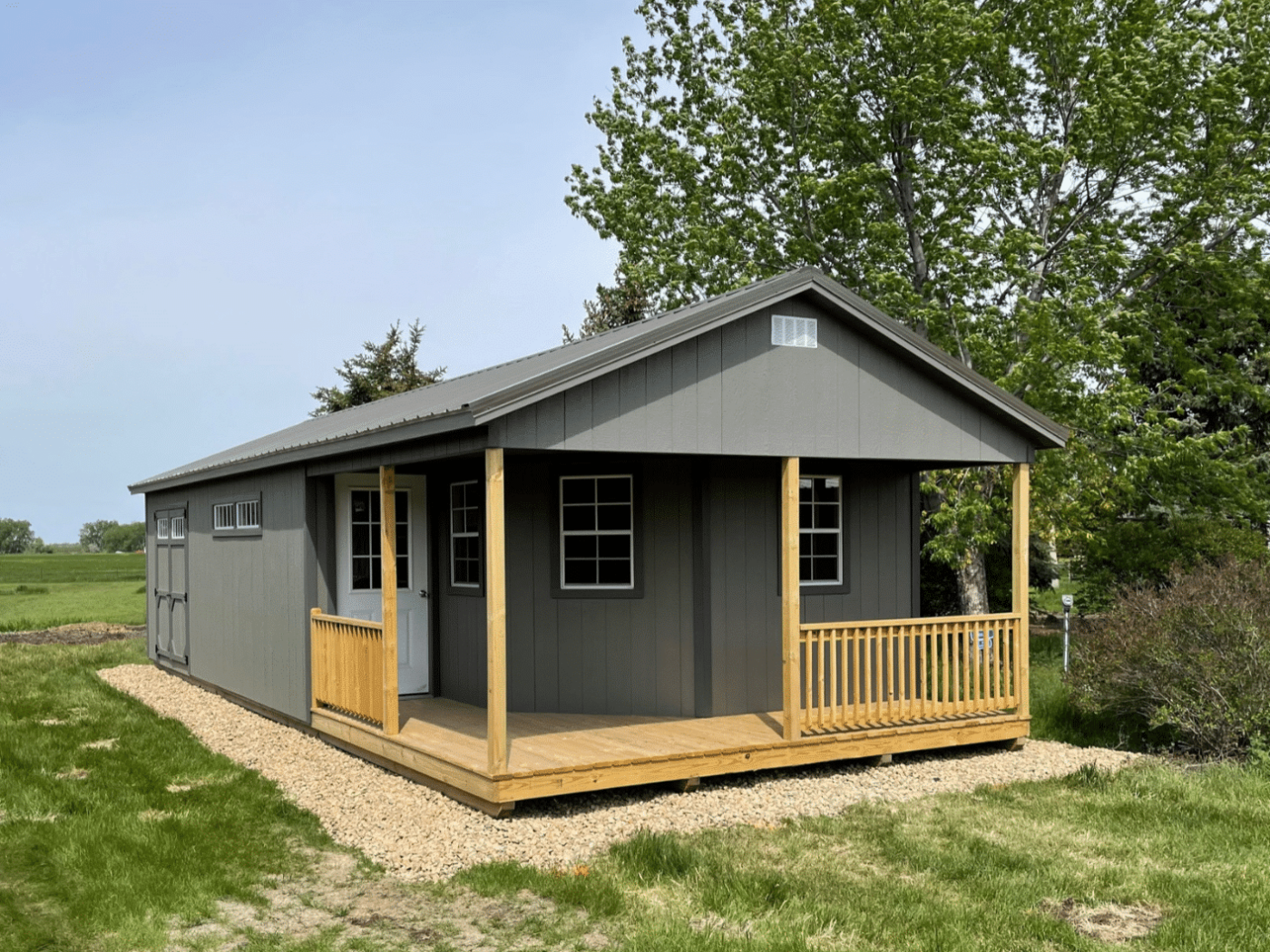 Gray a-frame cabin shed in backyard