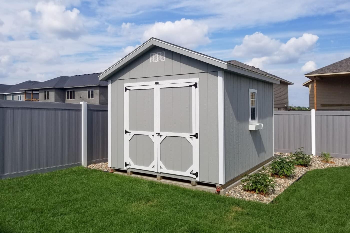 Grey a-frame storage shed in backyard