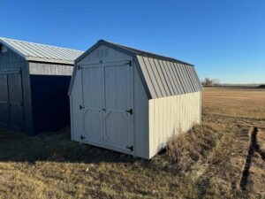 Low barn shed in field