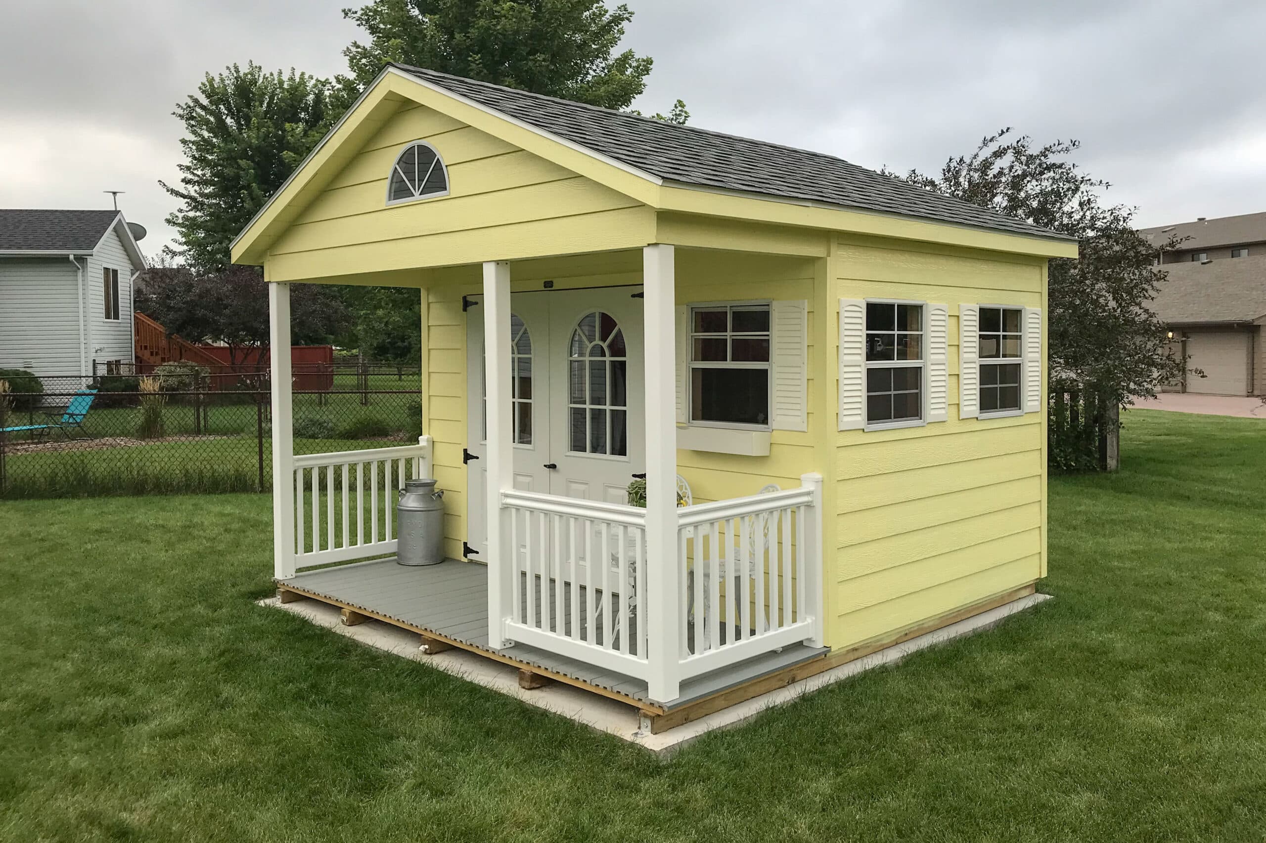 Yellow playhouse storage shed in backyard