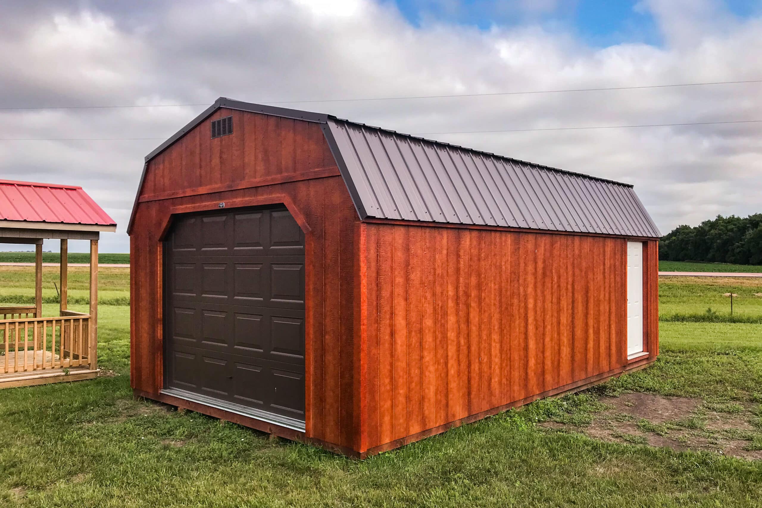 Red stained high barn garage shed on farm