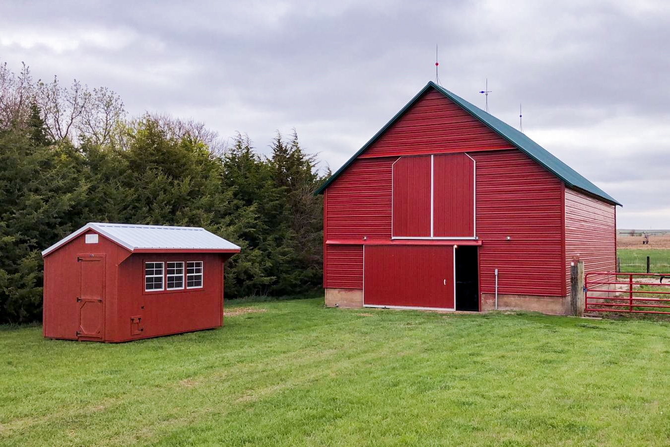 Red wooden Chicken Coop Shed next to barn