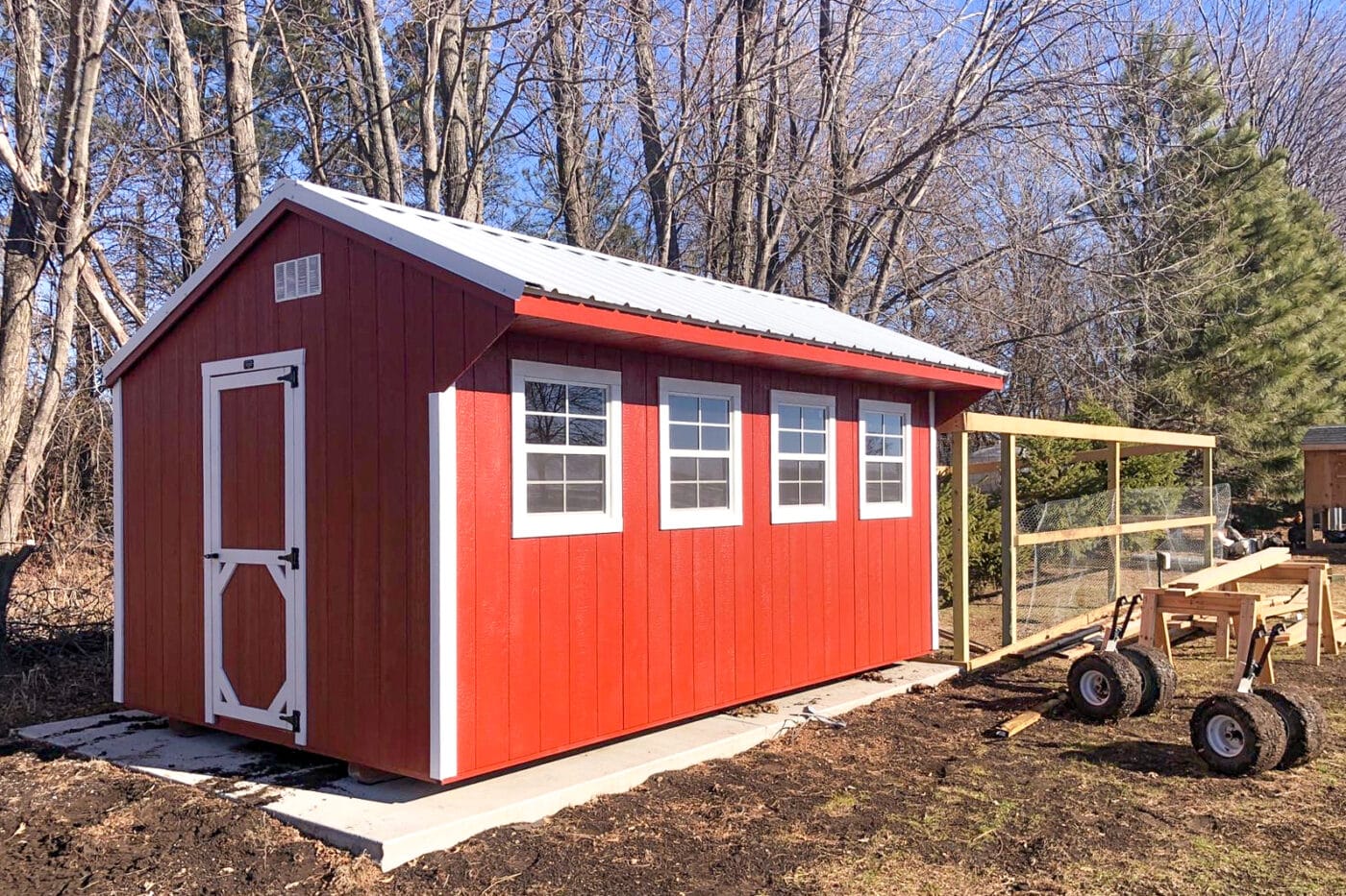 Red Wooden Chicken Coop Shed Next to Pen
