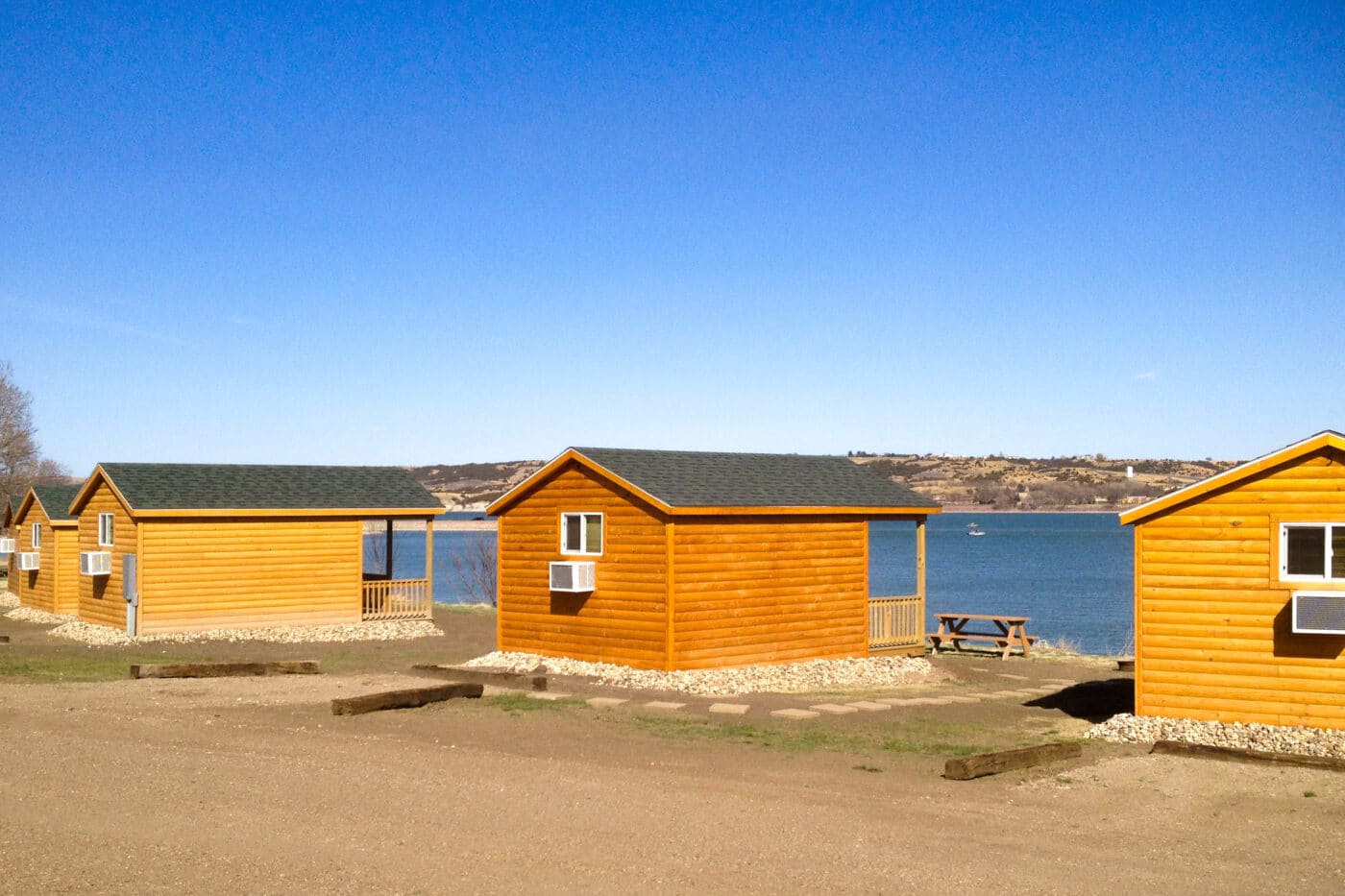 Several a-frame log side prefab cabins by lake