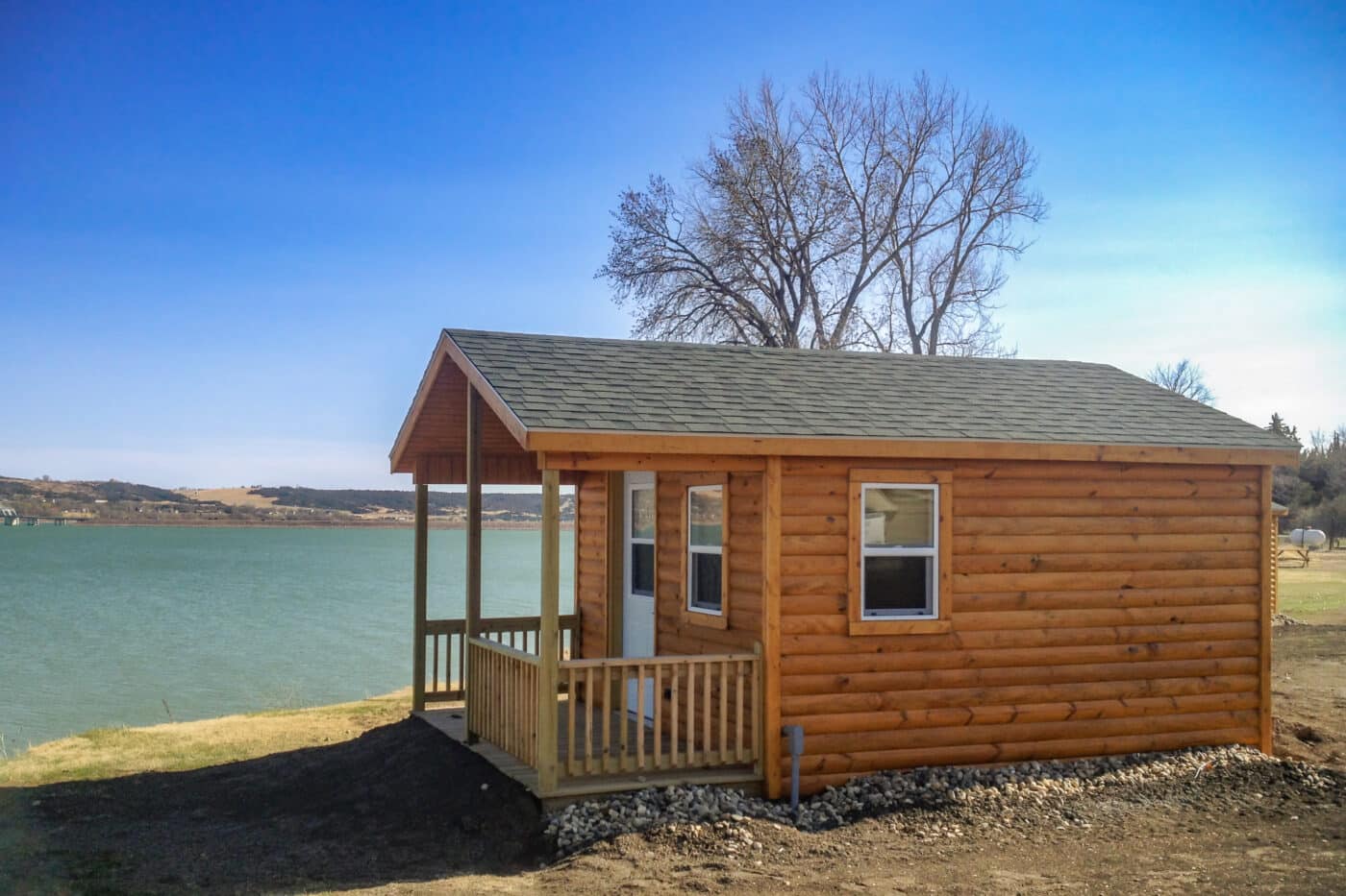 Brown stain A-Frame Cabin shed with log siding by lake