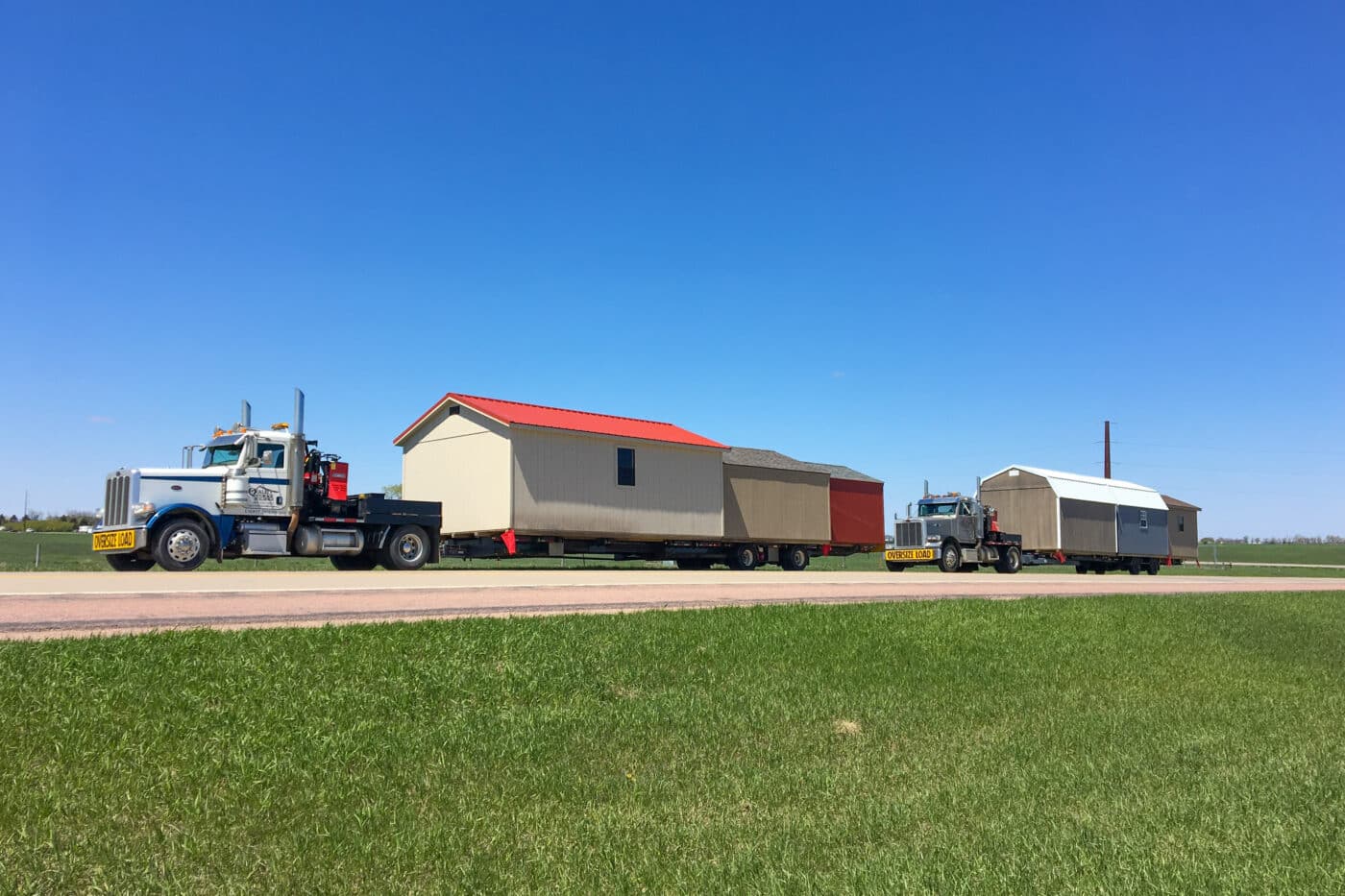 Truck delivering storage sheds