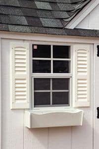 Window with Shutters and Window Box on side of shed