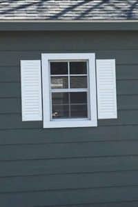 Window with Shutters on side of shed