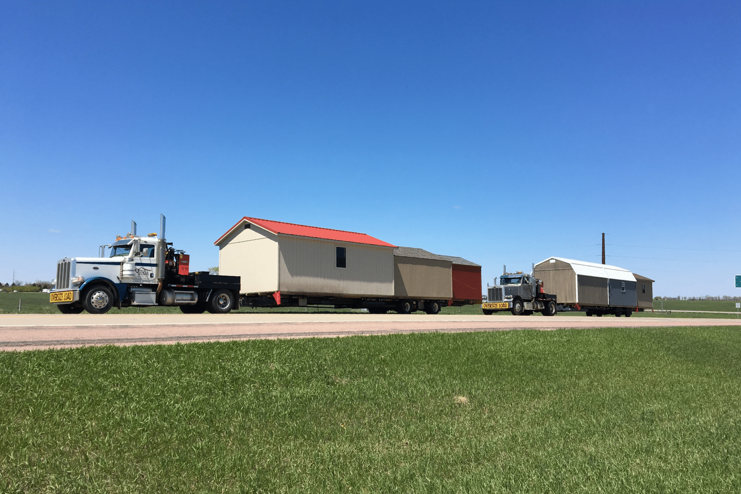 two trucks delivering sheds in brandon sd